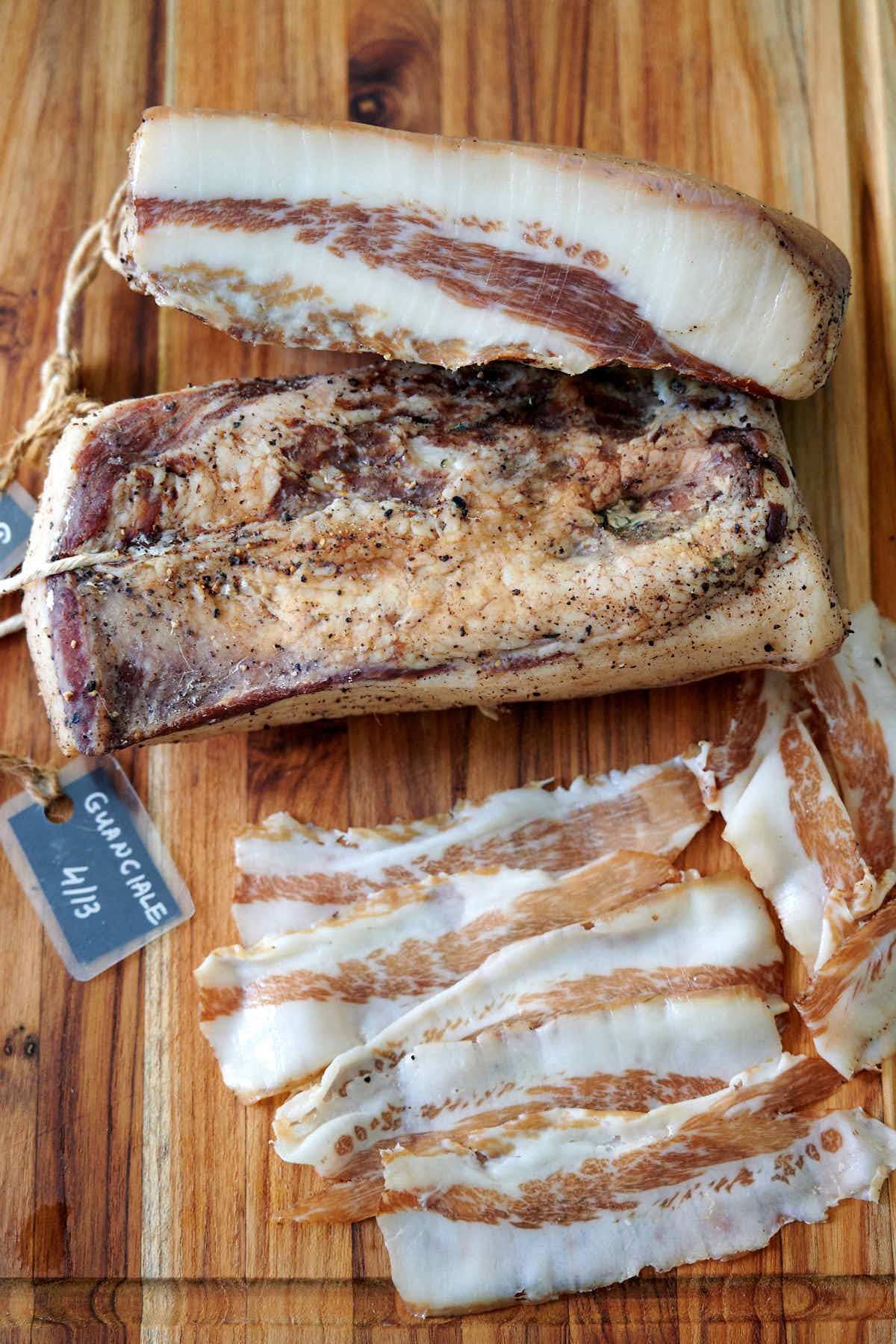 Homemade cured guanciale on a wooden board