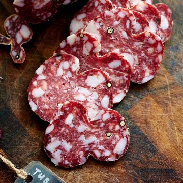 Sliced beautiful, rich, dark burgundy salame Toscano