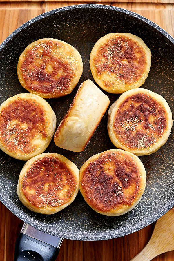 Sourdough English muffins on a frying pan