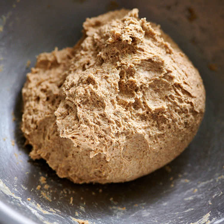 Mixing rye bread dough in a bowl.