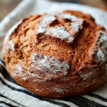 Sourdough rye bread on a kitchen towel.