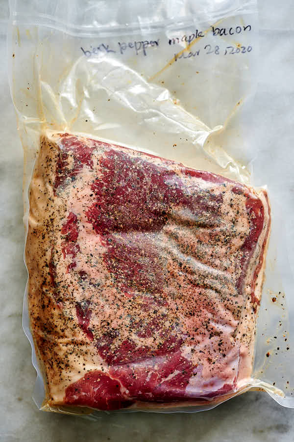 Bacon curing in a vacuum-sealed bag.