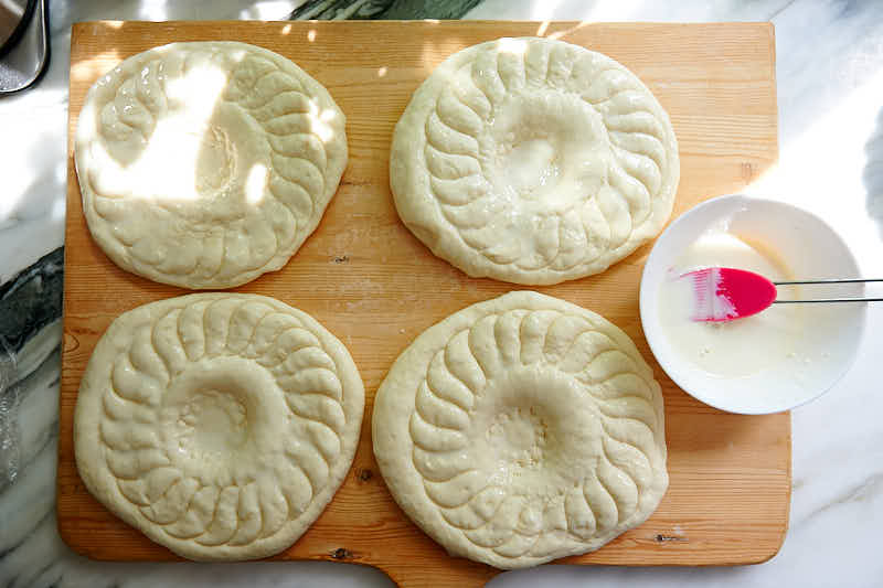 Brush dough with milk for Uzbek bread obi non.