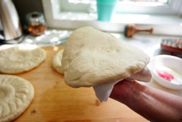 Loading dough in the oven Uzbek bread obi non.