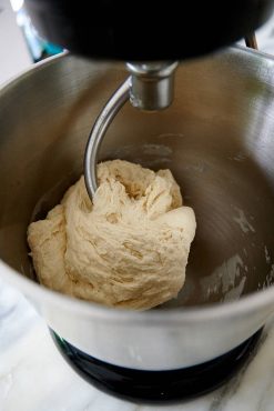 Mixing dough for Uzbek bread obi non.