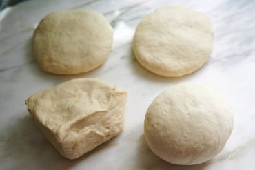 Dividing and shaping dough for Uzbek bread obi non.