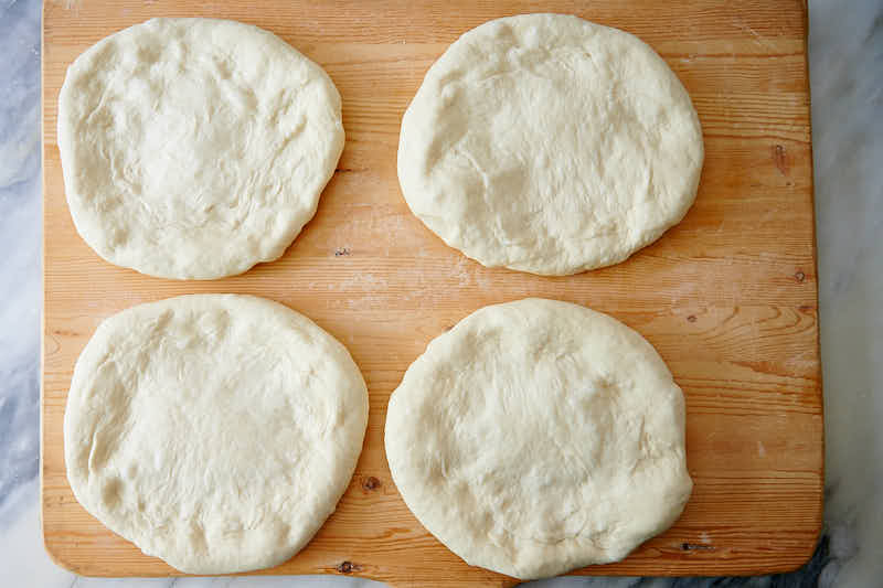 Stretching dough for Uzbek bread obi non.