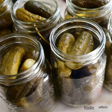 Stuffing fermented pickles in 1-quart jars.