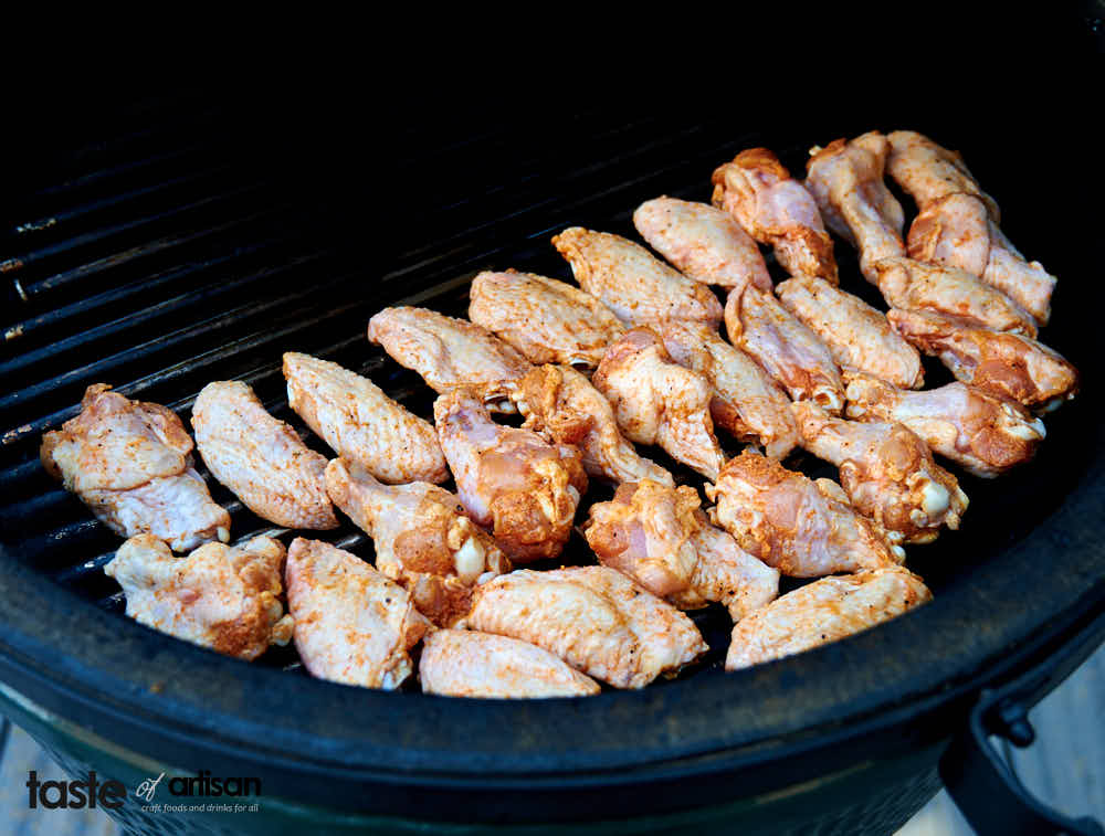 Smoking chicken wings over indirect heat in a two zone smoker setup.
