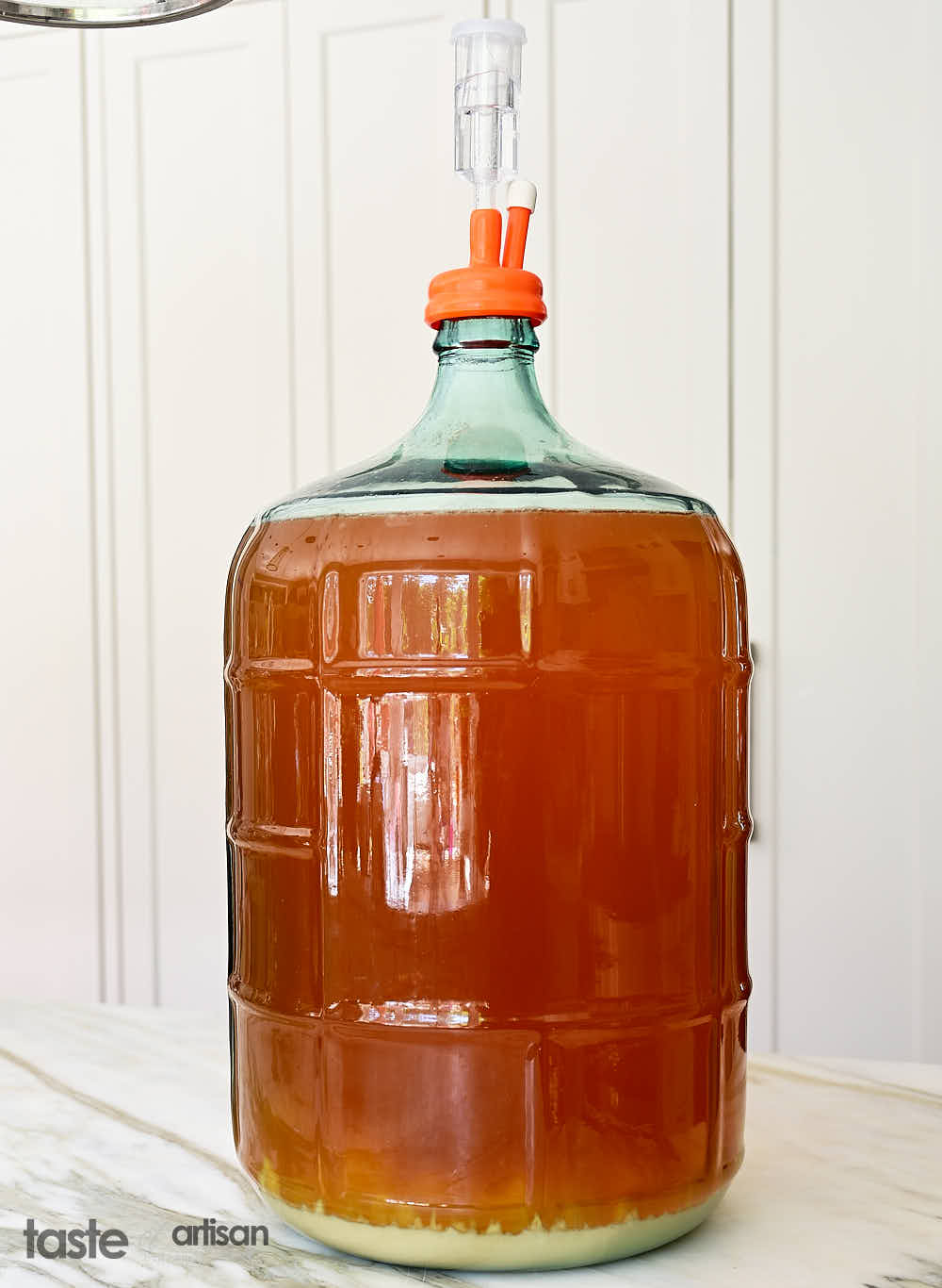 Hard cider fermenting in a 5 gallon glass carboy.