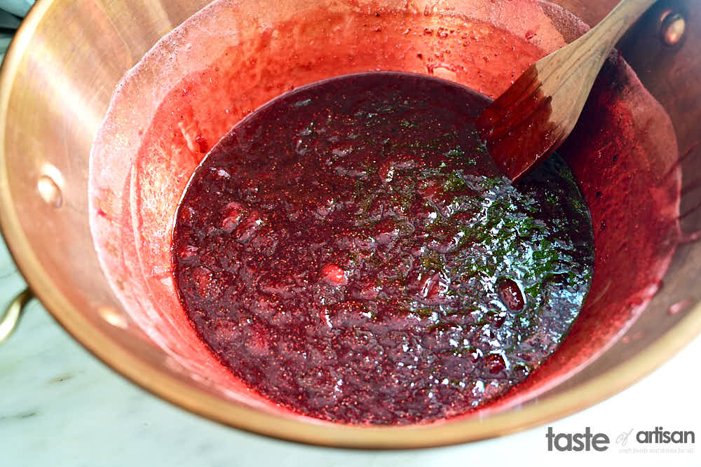 Strawberry jam in a copper jam pan.
