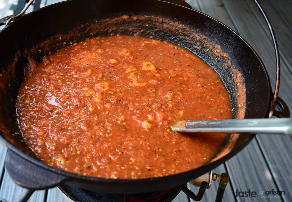 Cooking tomato sauce in a jambalaya pot.