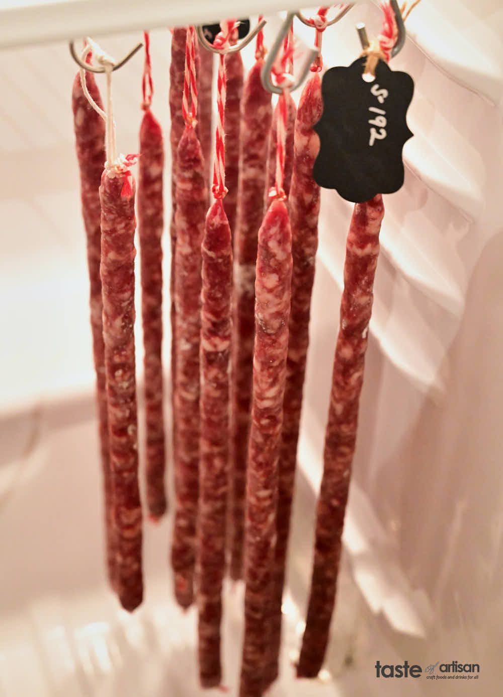 Salami sticks in meat chamber.