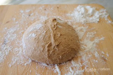 Beer bread dough on a working surface with flour.