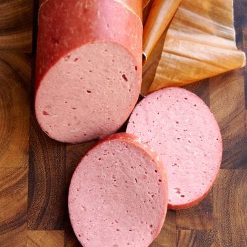 Doctor's sausage slices on a cutting board.