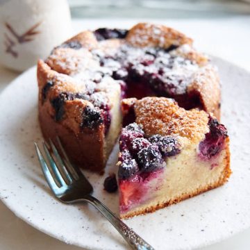 Berry cake made with mixed berries sliced on a serving platter.