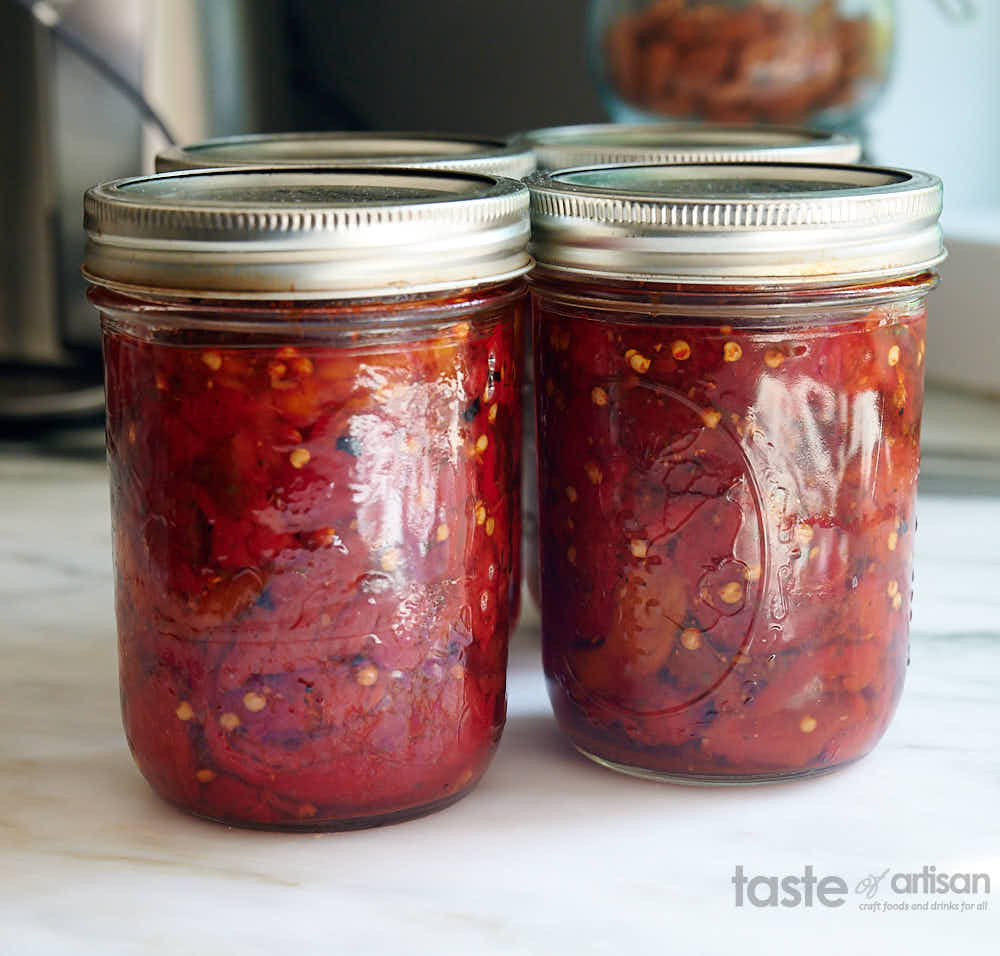 Fully processed canned peppers in glass pint jars.