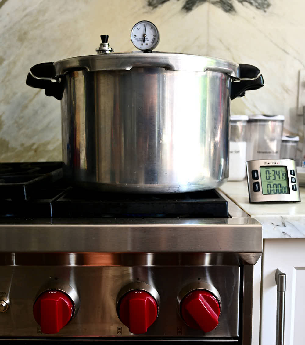 Pressure canner on a stove, making canned peppers.