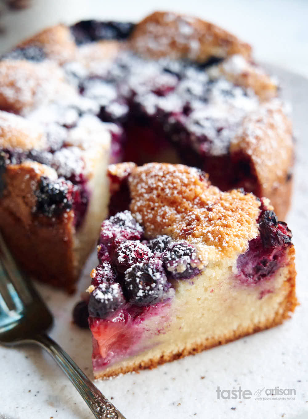 A slice of berry cake on a plate.