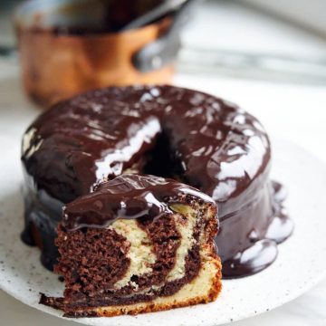 Zebra cake slice with fluffy, moist crumb with decadent chocolate glaze on the outside.