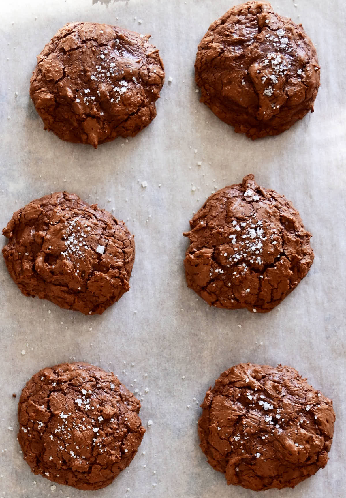 Dark chocolate cookies on a baking sheet.