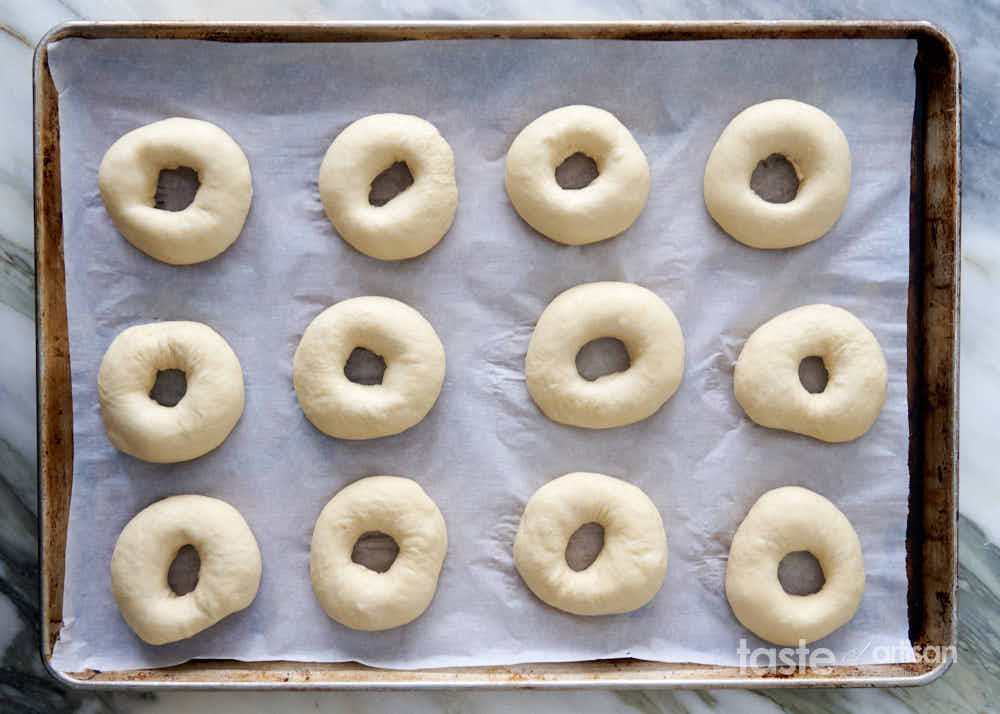 Bagel dough shaped into rings.