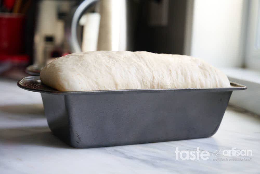 Dough proofing in a bread pan.