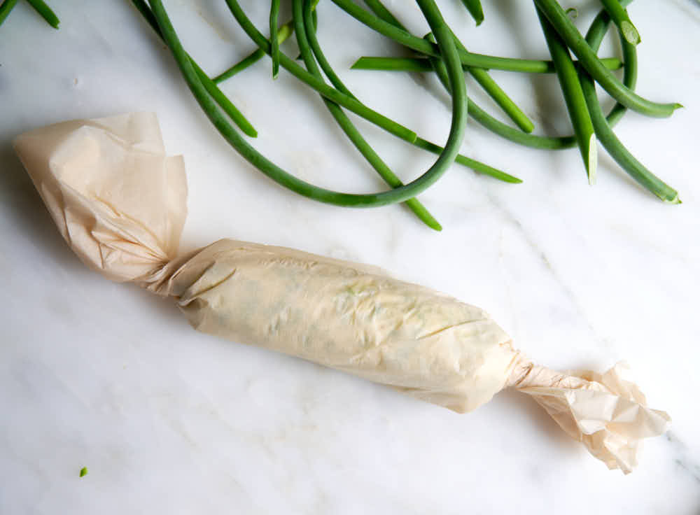 Compound butter lwrapped in parchment paper.