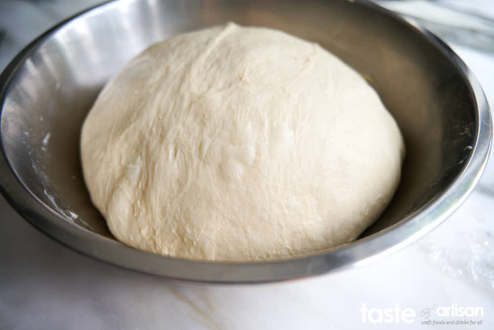 Neapolitan pizza dough shaped into a ball.