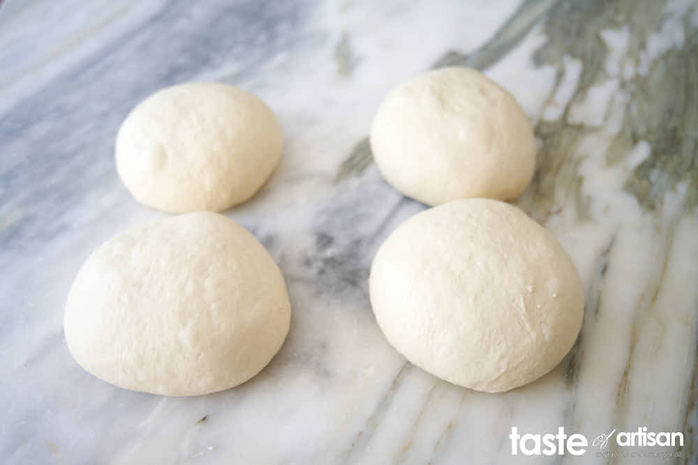 Pizza dough shaped into balls.