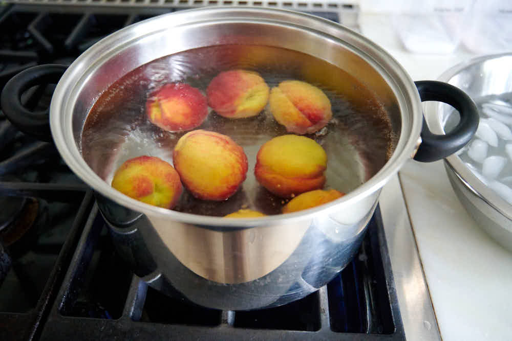 Blanching peaches in boiling water