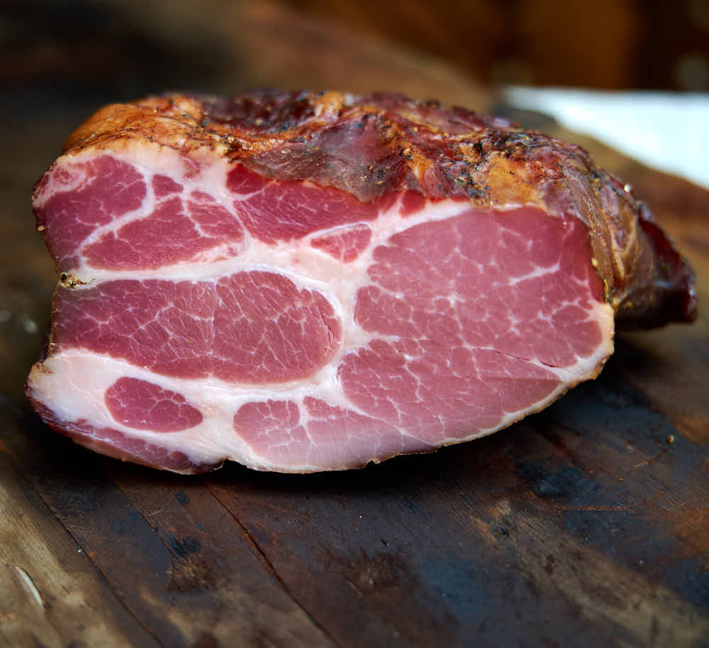 Buckboard bacon with dark red, marbled meat