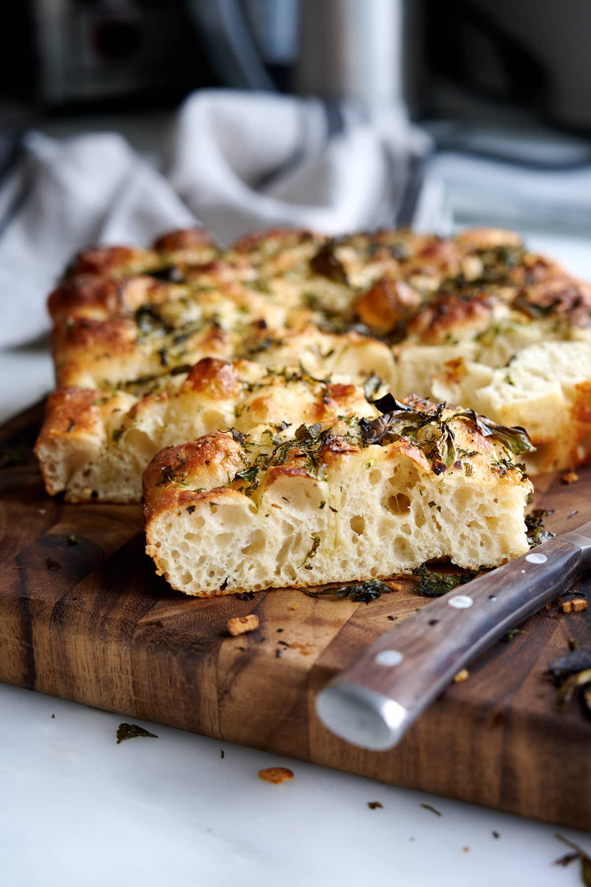 I could eat this focaccia bread every day if I could. There are many homemade focaccia recipes out there, but this one is special. The secret is in high hydration dough, no kneading, overnight fermentation in the fridge to develop robust flavor and a quick bake at high temperature to get a thin crispy crust and moist, airy crumb. You must try this focaccia recipe, with its simple yet very flavorful toppings, you will love it.