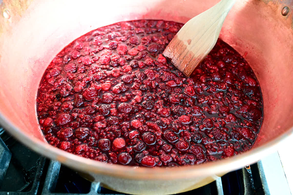 Making raspberry jam in a copper jam pan.