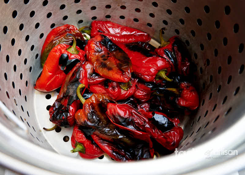 Draining roasted peppers ang eggplant.