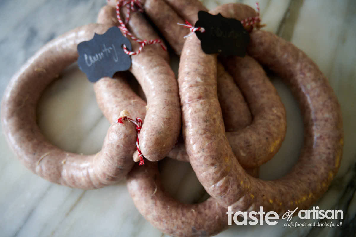 Country sausage stuffed into casings and tied into rings.