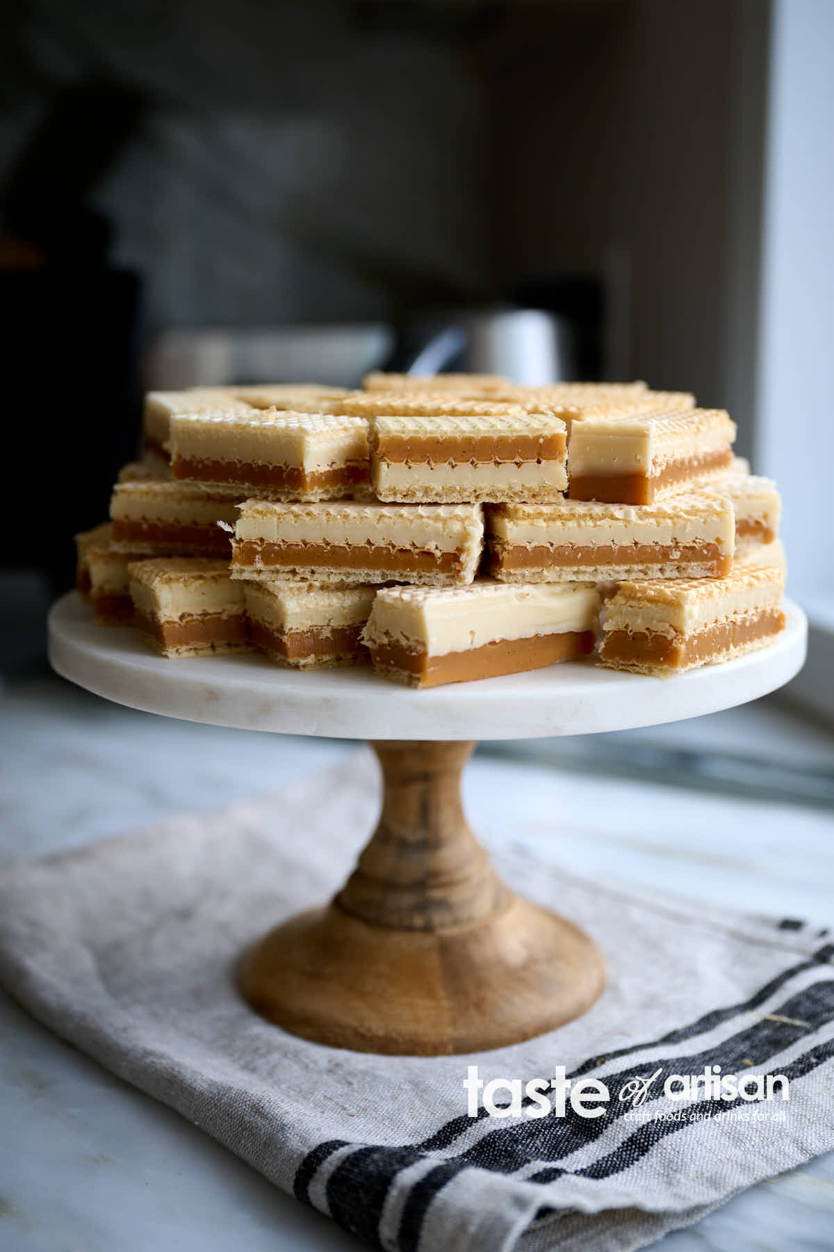 Scrumptious caramel and white chocolate ganache wafer bars made with silky smooth, soft, and chewy vanilla caramel, exquisite white chocolate ganache melts as soon as you put it in your mouth, and thin crunch wafers.