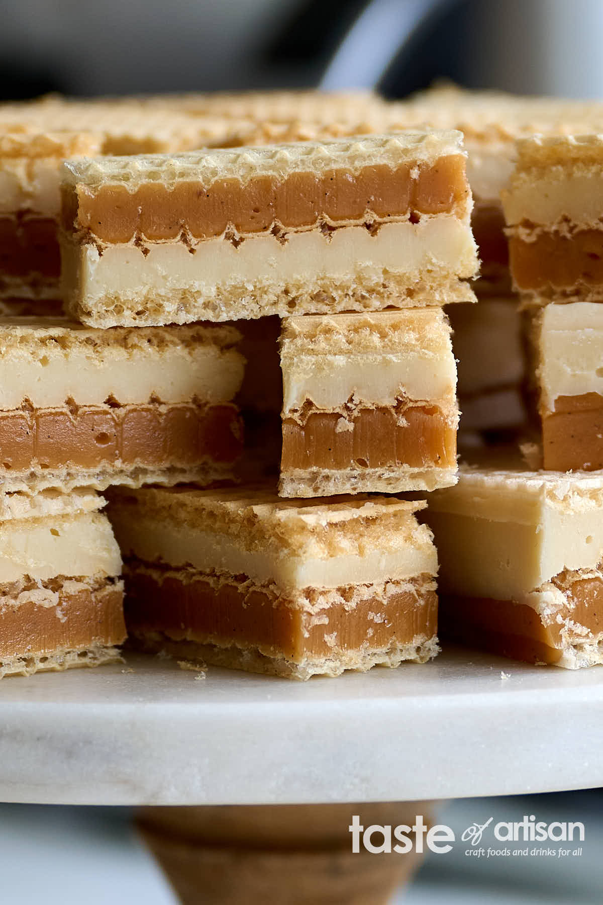 Scrumptious caramel and white chocolate ganache wafer bars made with silky smooth, soft, and chewy vanilla caramel, exquisite white chocolate ganache melts as soon as you put it in your mouth, and thin crunch wafers.