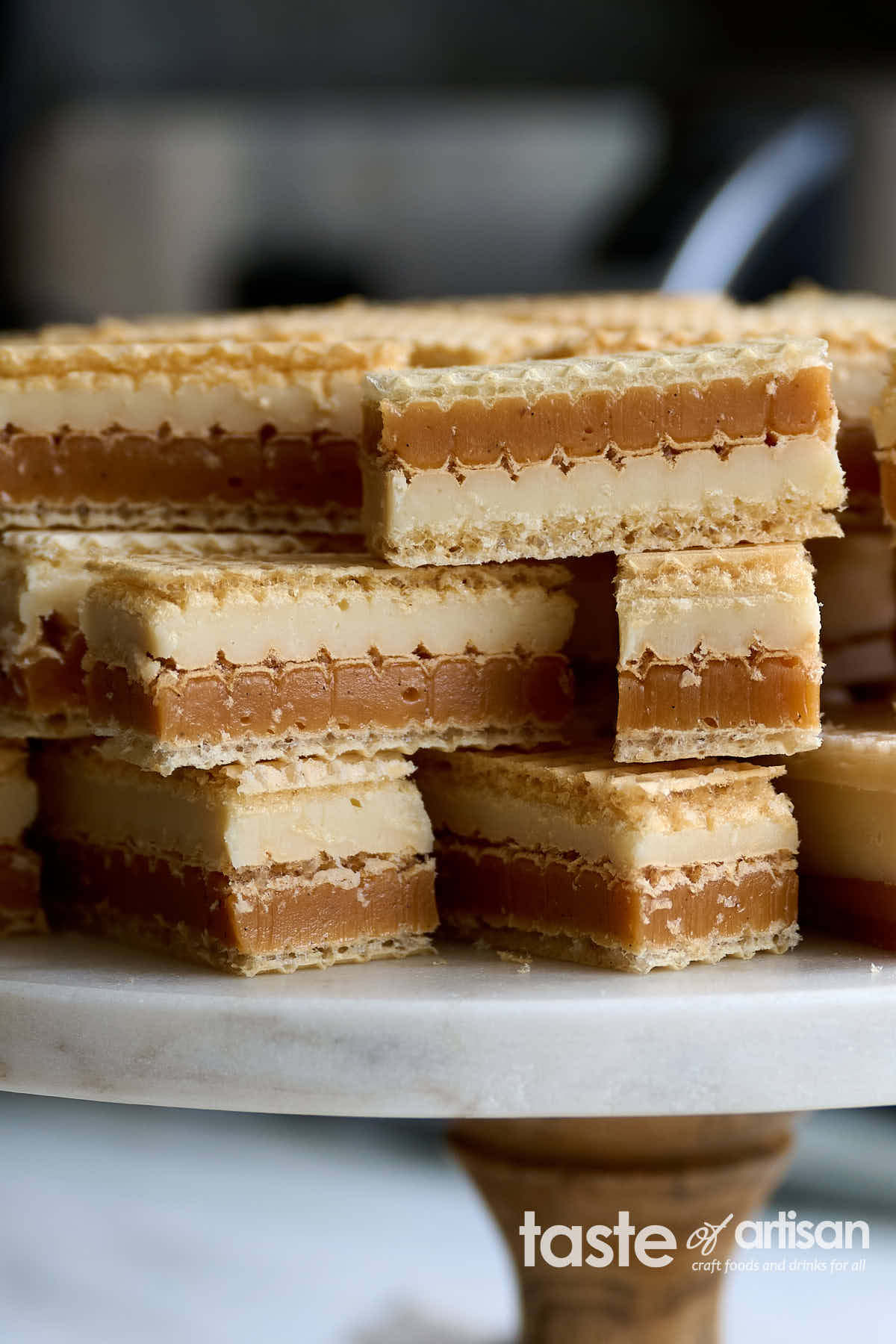 Decadent soft caramel and white chocolate ganache wafer bars made with silky smooth, soft, and chewy vanilla caramel, exquisite white chocolate ganache melts as soon as you put it in your mouth, and thin crunch wafers.