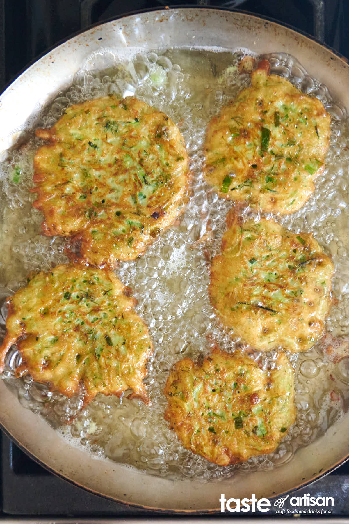 Frying zucchini pancakes.