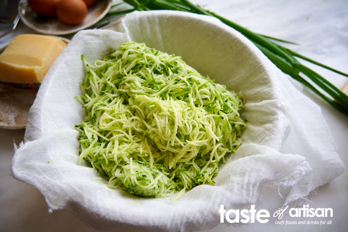Shredded zucchini in cheesecloth. 