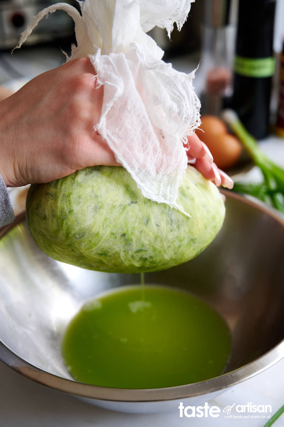 Squeezing juice from shredded zucchini.