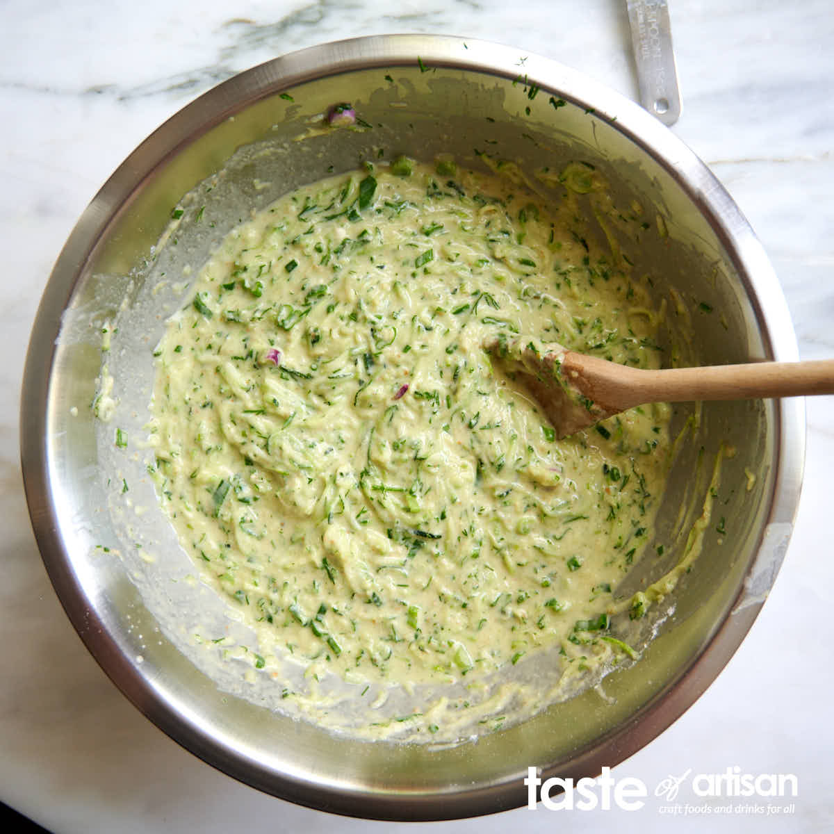 Making zucchini pancake batter.