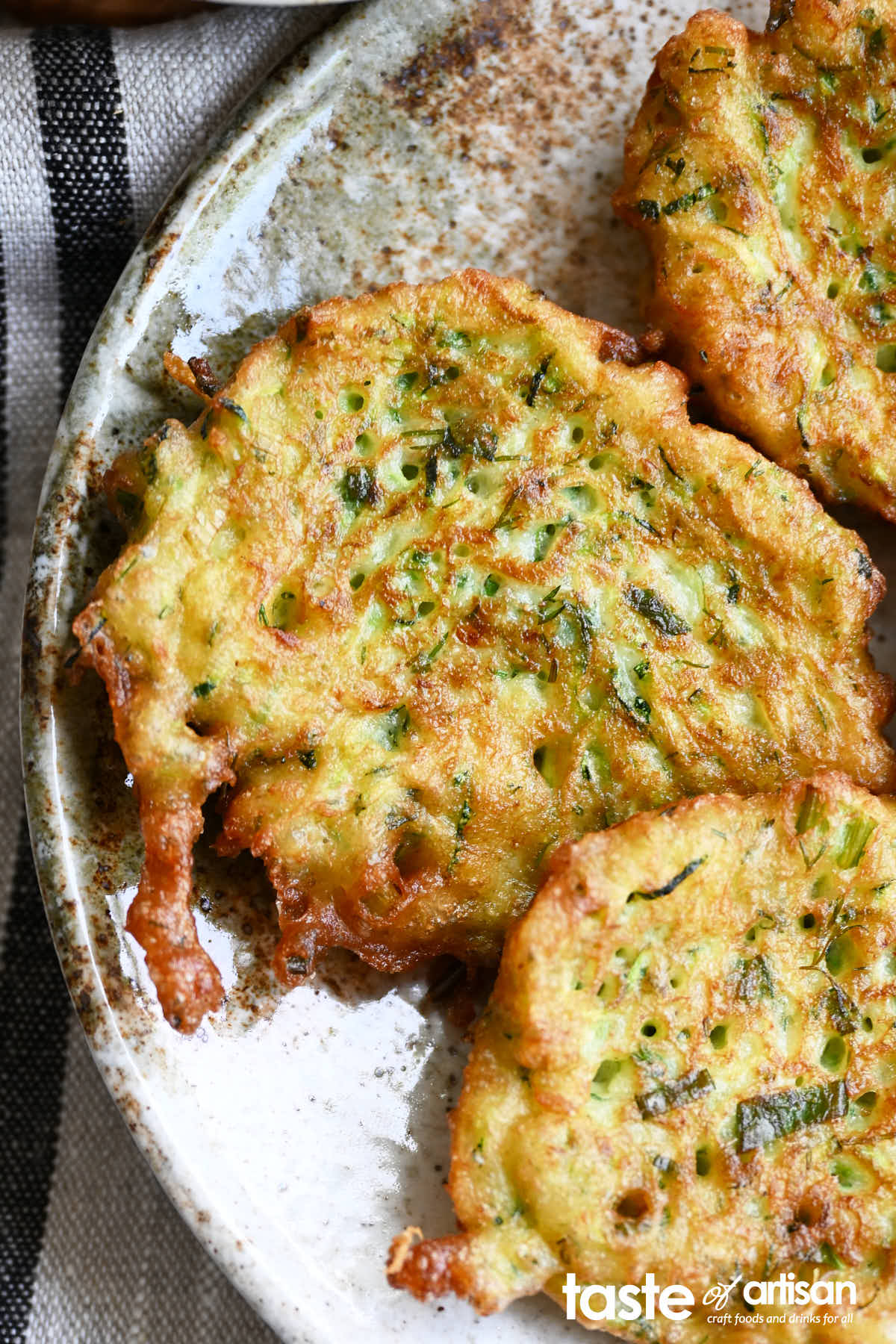 Zucchini pancakes that utilize sourdough starter discard to give them an airier texture and an improved flavor.